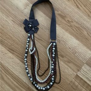 Ribbon necklace with chains, pearls, and bow